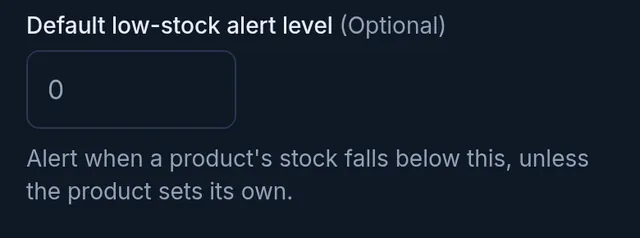 The Default low-stock alert level field in the shop settings, with its explanation below